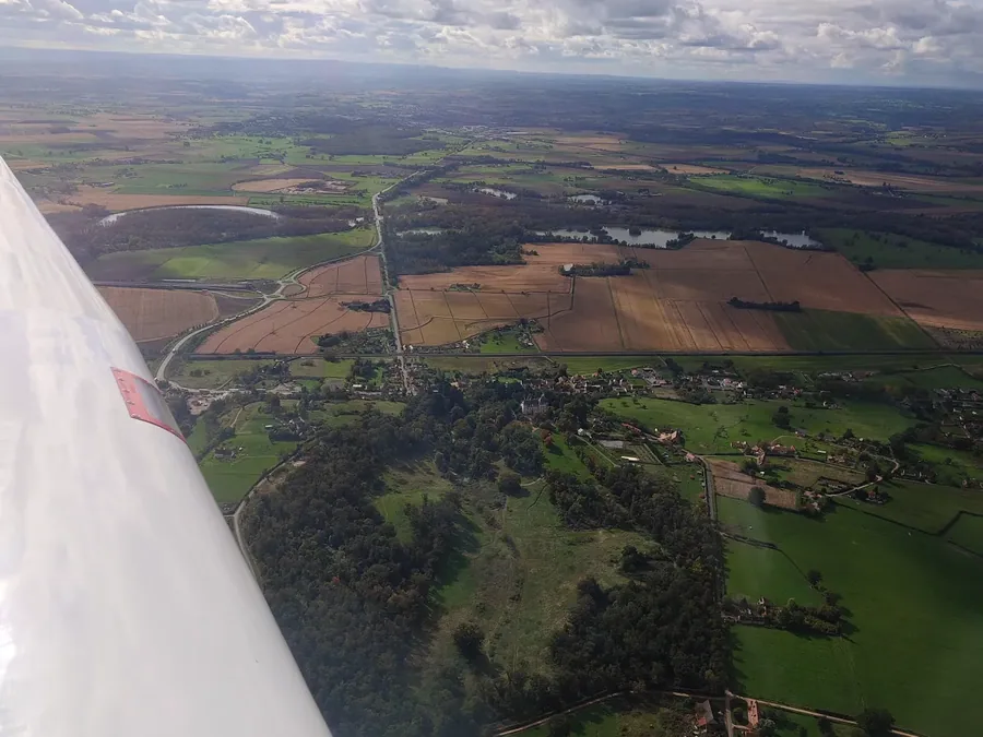 Aerial view of Domaine de Chazeuil — château, grounds, woodland, and rolling countryside