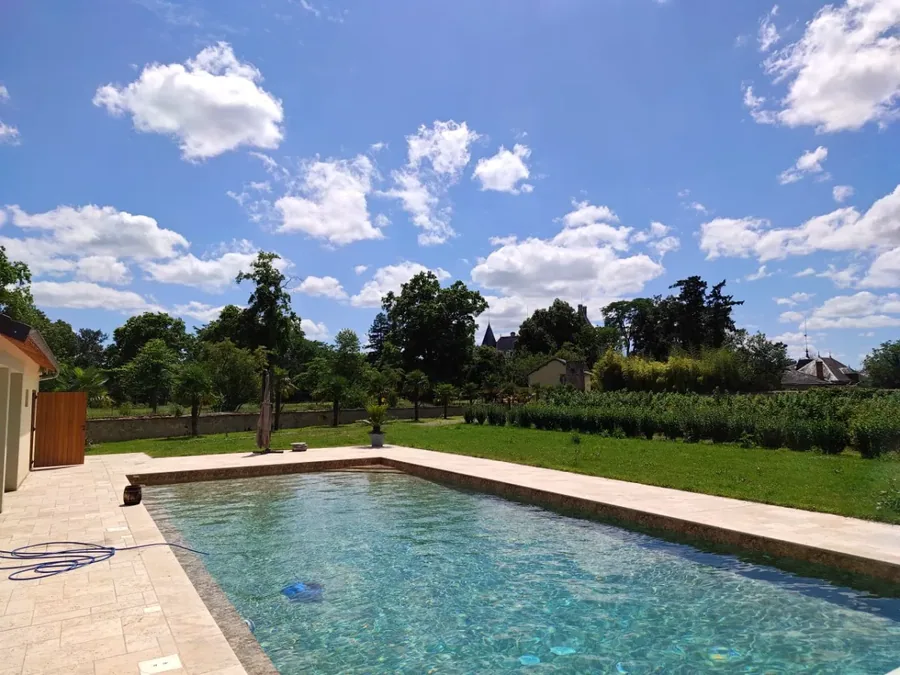 Wide view of pool surrounded by gardens