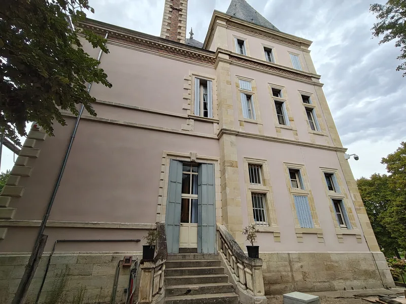 The cream stone wing with its balustraded terrace stair