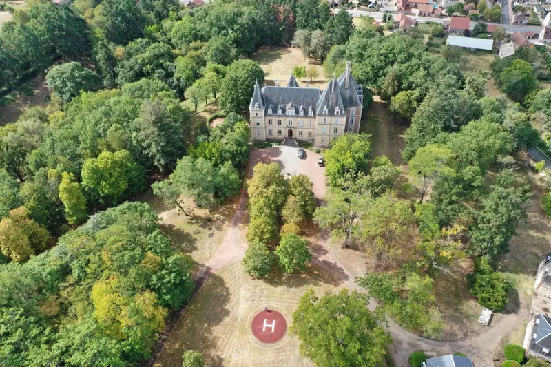 Aerial view over the chateau and its wooded park