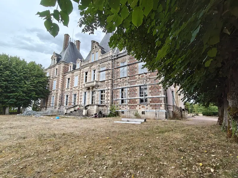 The brick wing seen from beneath the tree canopy