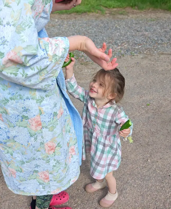 A mother and her daughter laughing together outdoors