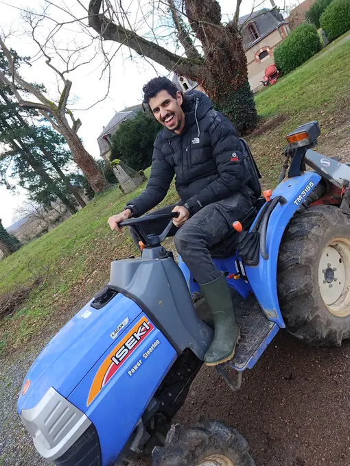 Working the estate on the small tractor with the dog alongside