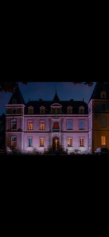 The facade washed in warm light after dark