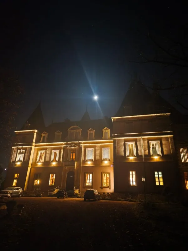 Warm light glowing from the windows on a clear moonlit night