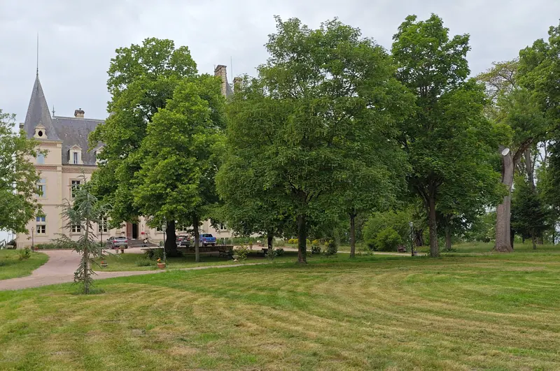 The chateau seen across open parkland on a bright afternoon