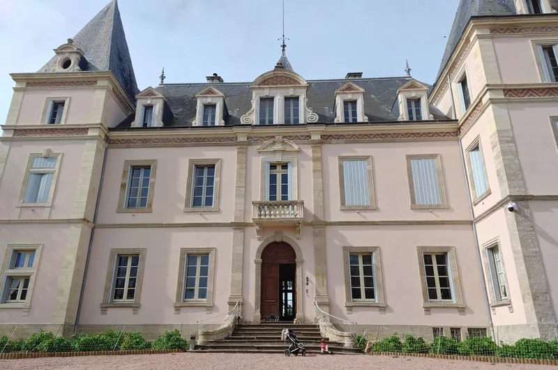 The chateau frontage, clean and symmetrical, from the drive