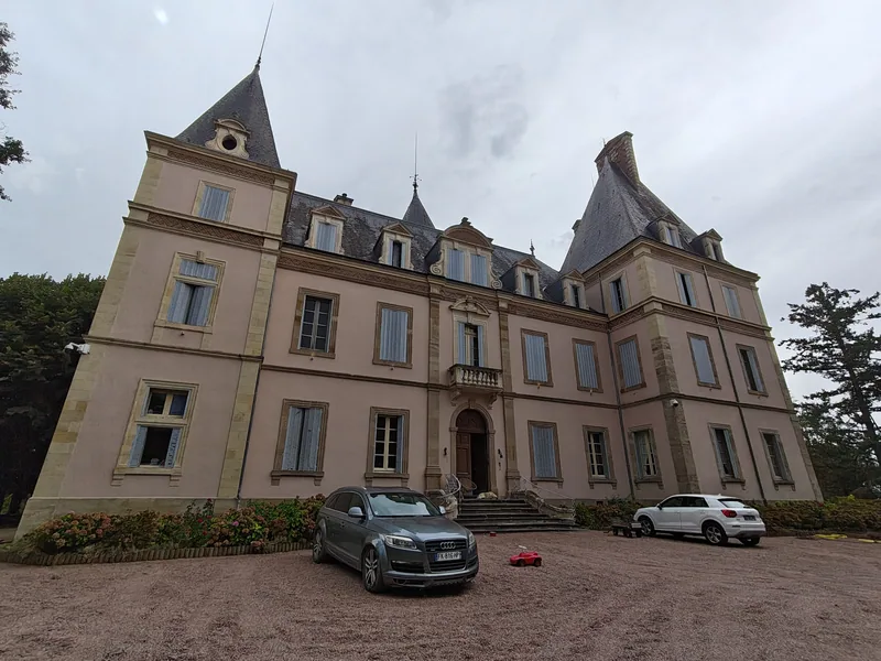 The chateau across its gravel forecourt