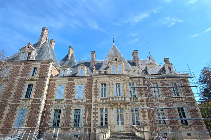 Wide view of the full frontage beneath a deep blue sky
