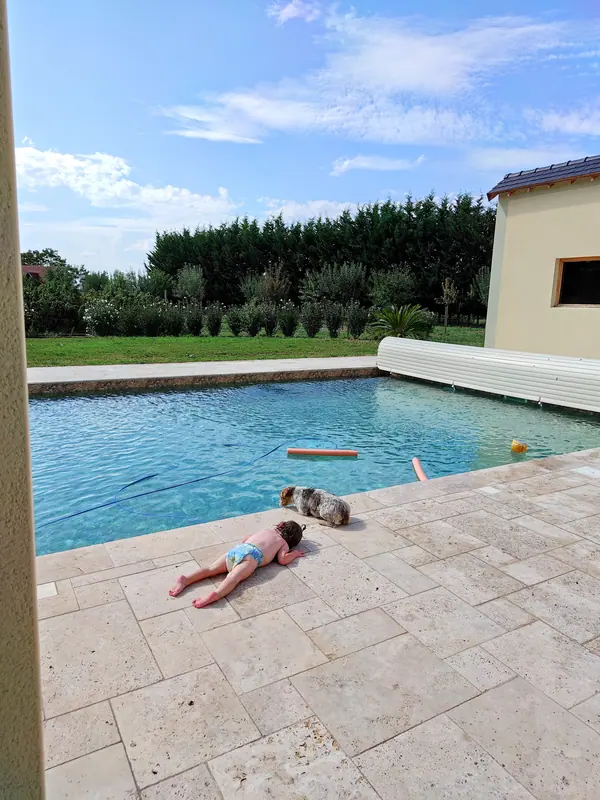 Family swimming and relaxing beside the estate pool