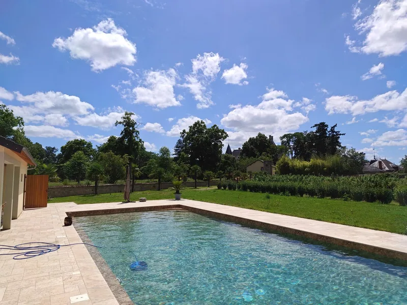 The estate swimming pool, turquoise water under a bright summer sky