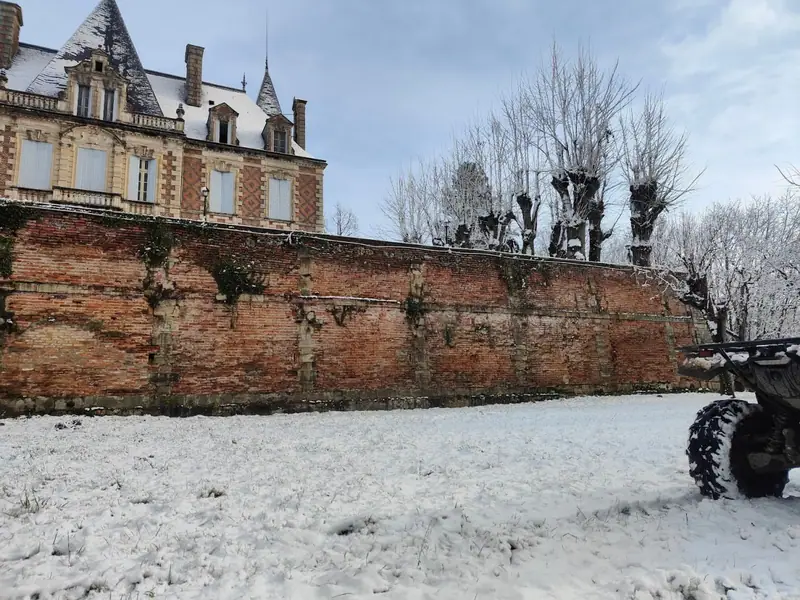 The brick retaining wall under winter snow
