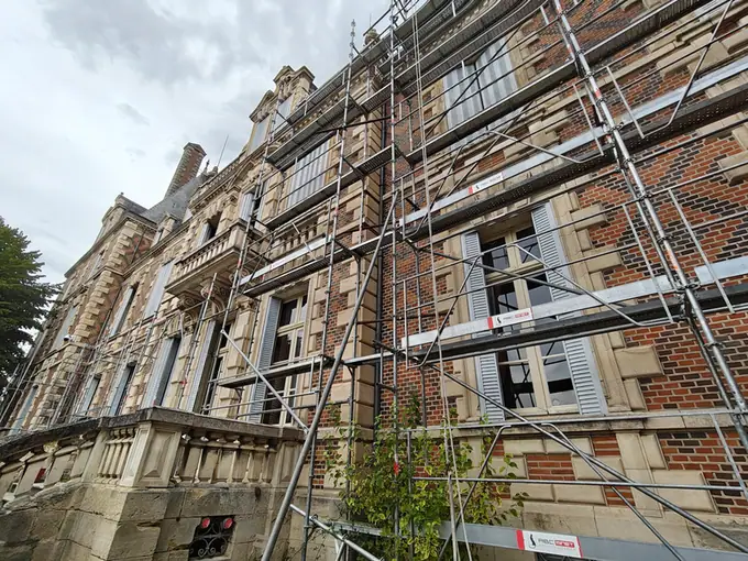 Scaffolding standing hard against the brick elevation